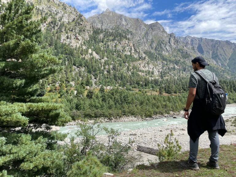 Naveen Kumar overlooking the Baspa River and mountains in Chitkul