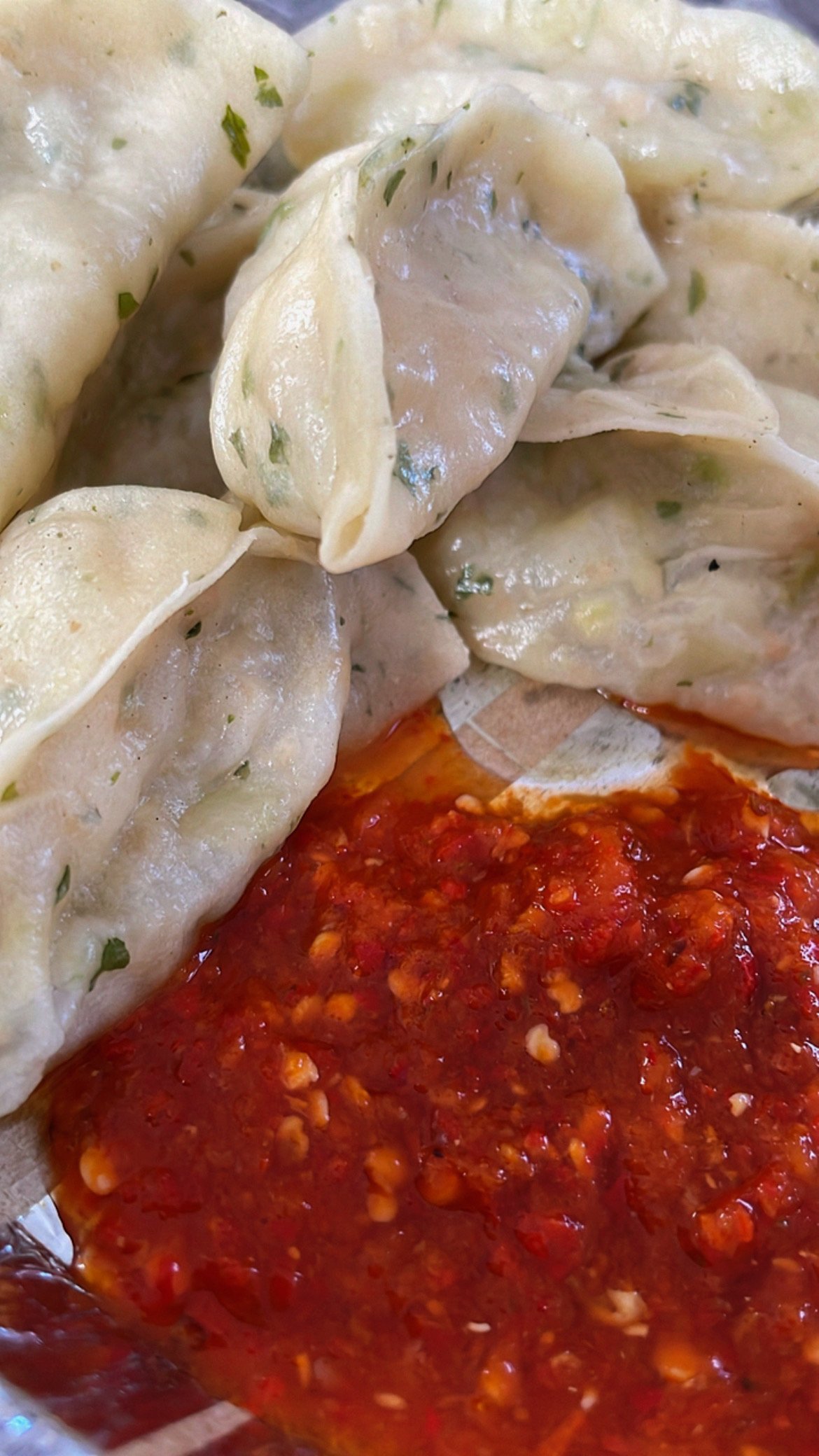 Steamed momos with red chilli chutney served in Mana Village