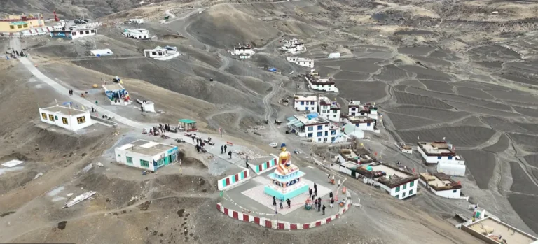 Aerial view of Langza village, Buddha statue, houses and terraced fields in Spiti Valley
