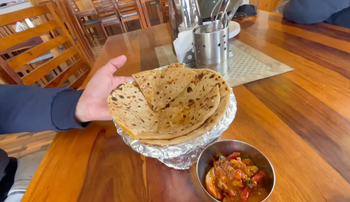 Hot aloo parathas and pickle served for breakfast at Tara Guest House in Mudh village