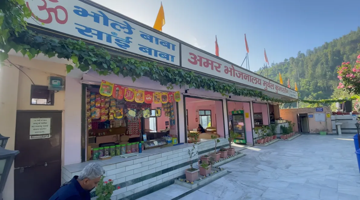 Front of Amar Bhojanalaya near Narkanda with signboard, shop counter and flowering plants