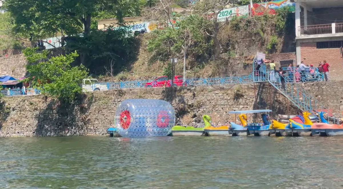 Water roller and colourful recreational boats beside Bhimtal Lake