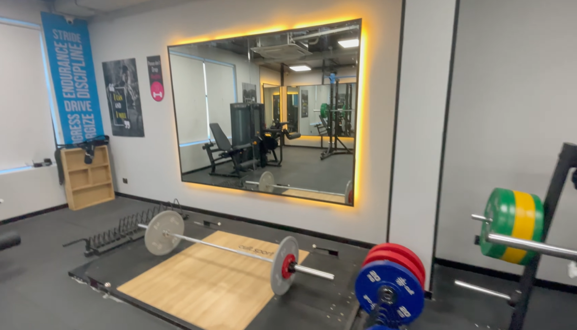 Barbell lifting platform with weight plates at Cult Gym Sector 57