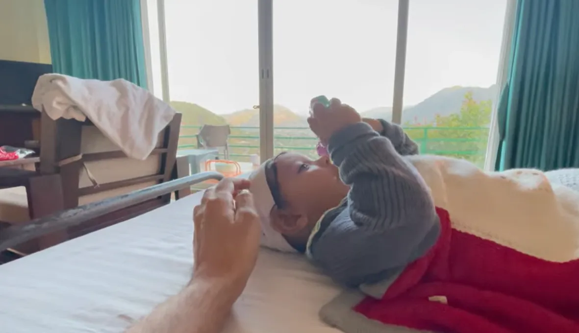Baby resting in a Naukuchiatal room overlooking the hills
