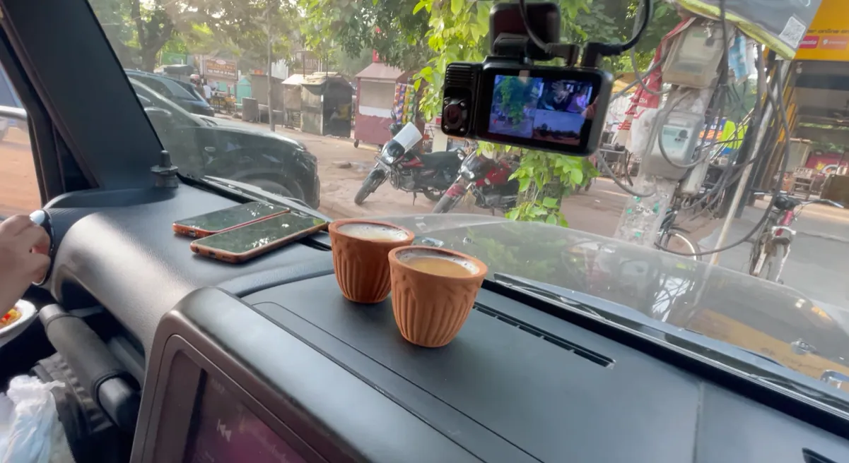 Two clay cups of chai on the dashboard after reaching Gurgaon
