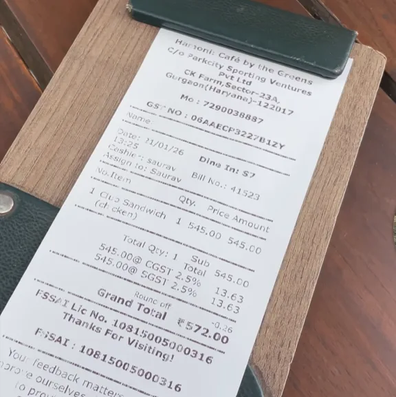 Hamoni Cafe Gurgaon bill showing ₹545 chicken club sandwich and ₹572 grand total