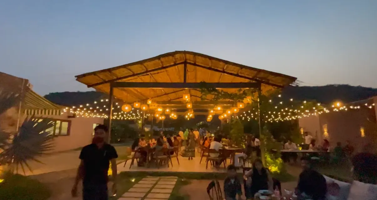 Warm hanging lights over the outdoor dining area at Jugnoo Cafe