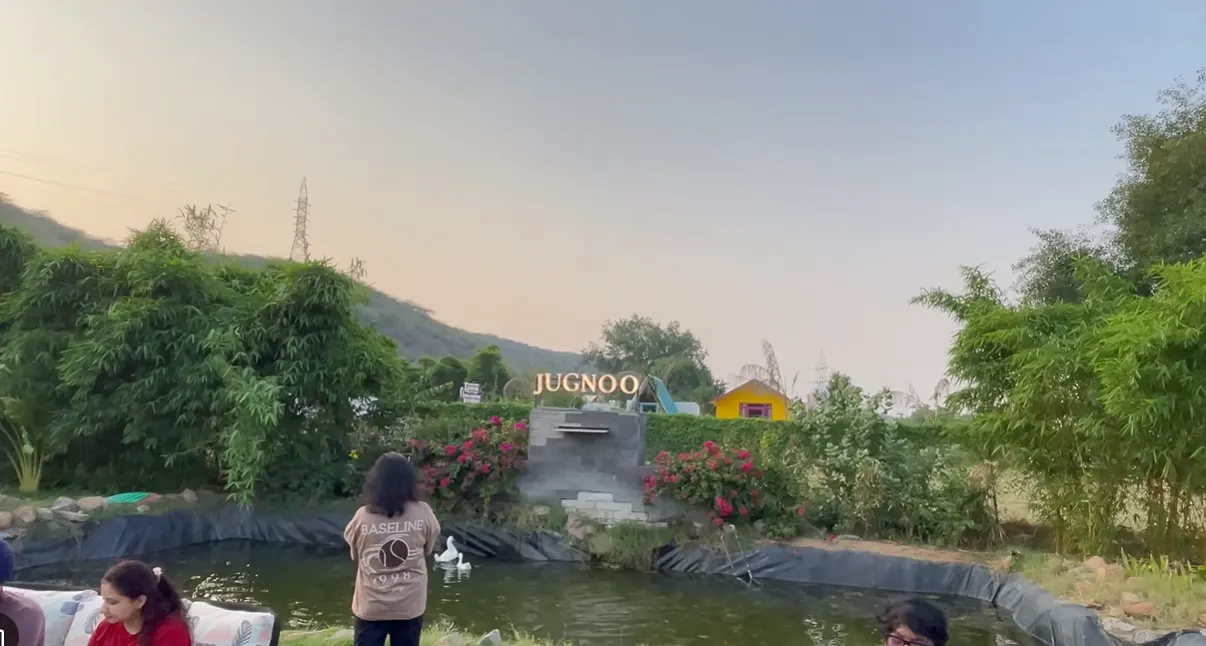 Jugnoo Cafe sign behind a pond and garden near Leopard Trail