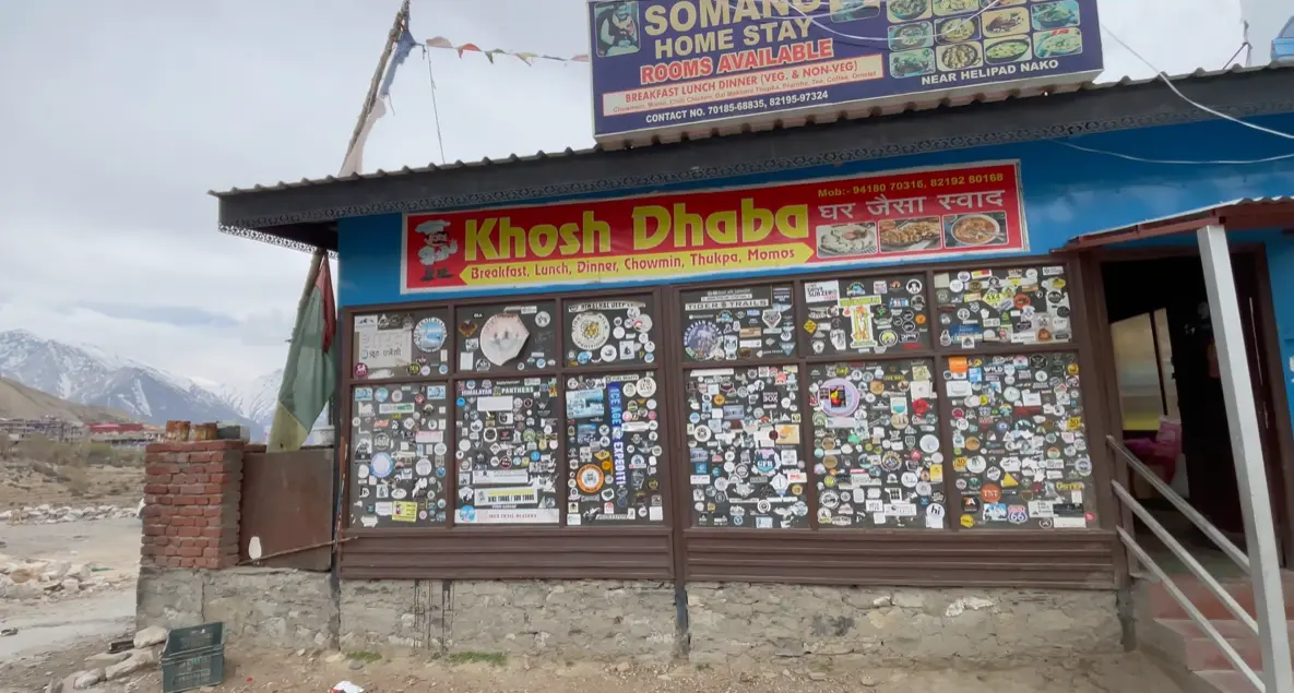Khosh Dhaba and Somang Home Stay signs near the entrance to Nako village