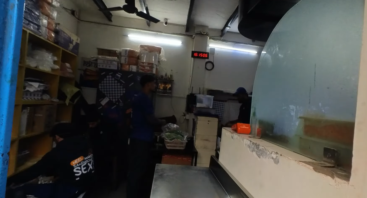 Staff working inside the compact Lexi's sandwich kitchen