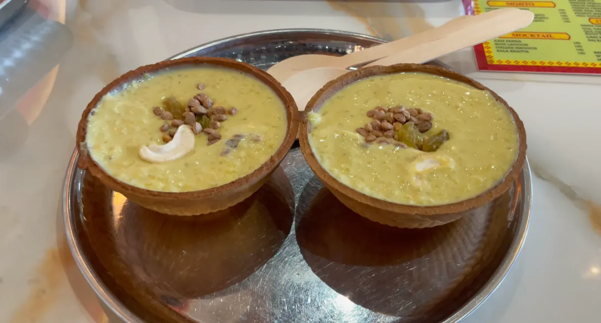 Two clay bowls of creamy dessert topped with nuts at Moga Haveli