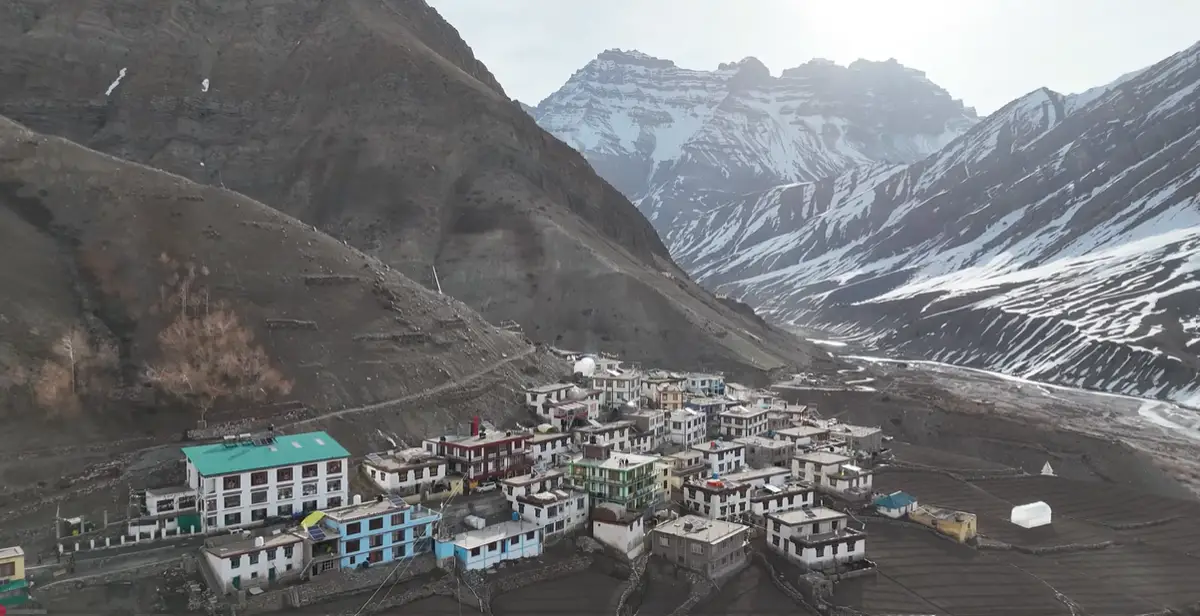 Wide aerial view of Mudh village, fields and snow-lined mountains in Pin Valley