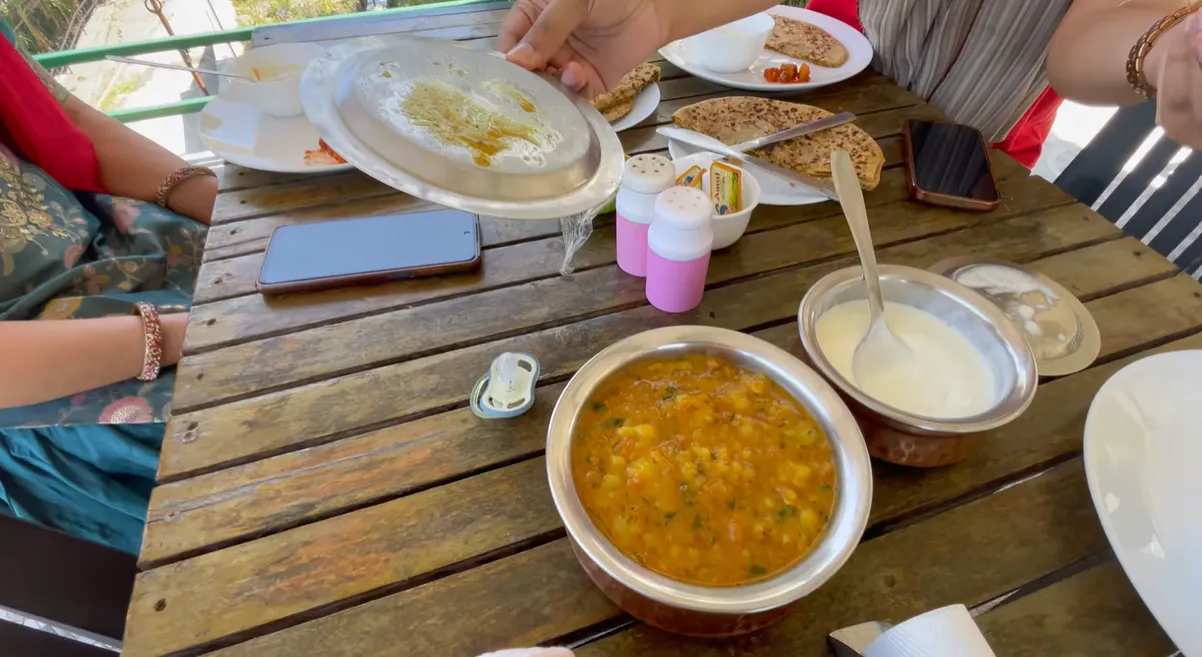 Parathas, puri bhaji and curd served for breakfast in Naukuchiatal