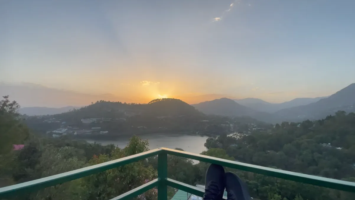 Sunset over Naukuchiatal Lake seen from the suite balcony railing