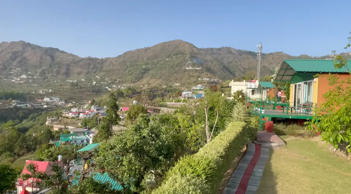 Cottages and green hillside at our Naukuchiatal stay