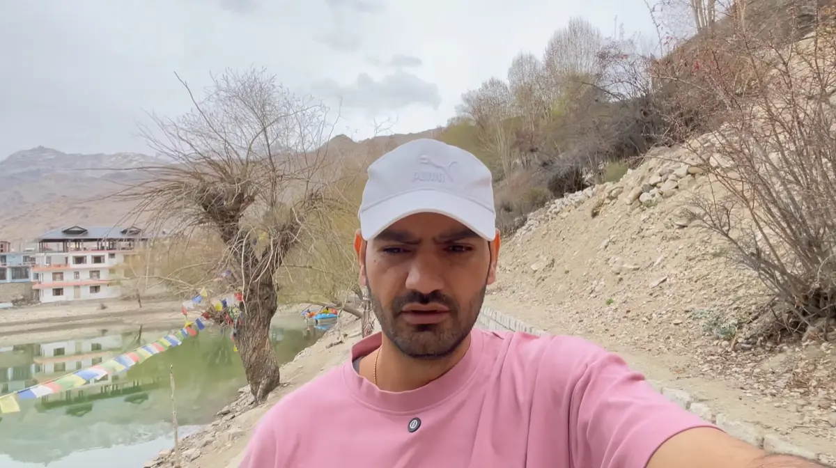 Naveen Kumar walking beside Nako Lake during a Kinnaur to Spiti road trip