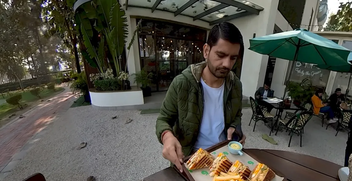 Naveen carrying the chicken and egg sandwich at Hamoni Cafe