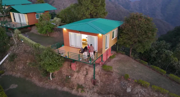 A family standing on the balcony of a private hillside suite at Nest and Hives