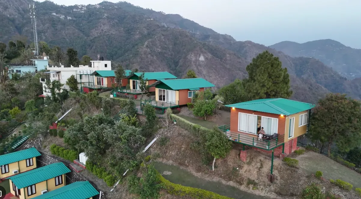 Aerial view of Nest and Hives cottages arranged across a hillside in Naukuchiatal