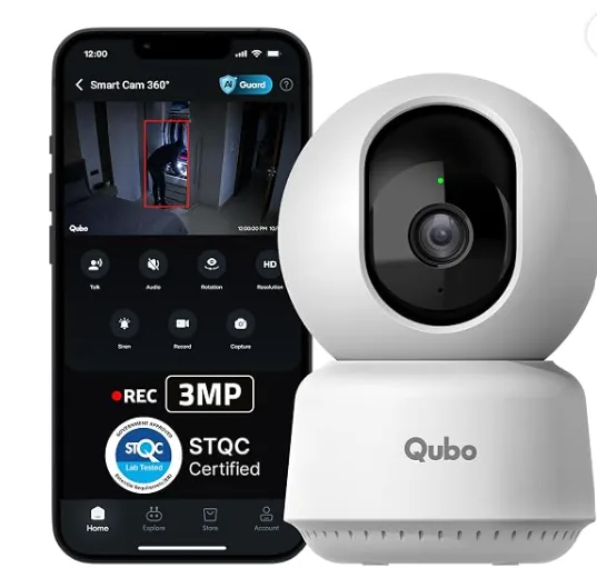 White Qubo Smart Cam 360 beside a phone showing the Qubo monitoring app