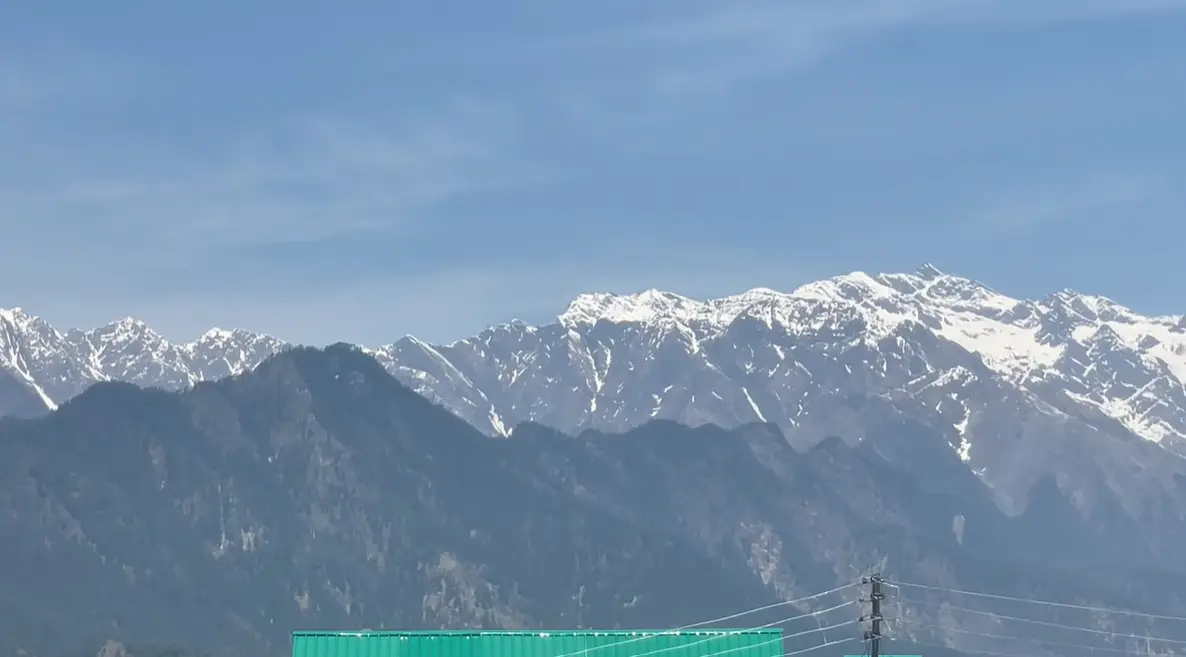 Snow-covered Himalayan peaks seen from Sarahan under a clear blue sky