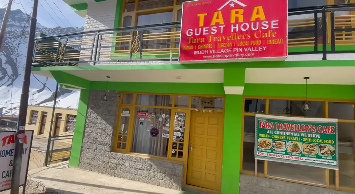 Green exterior of Tara Guest House and Tara Travellers Cafe in Mudh village Pin Valley