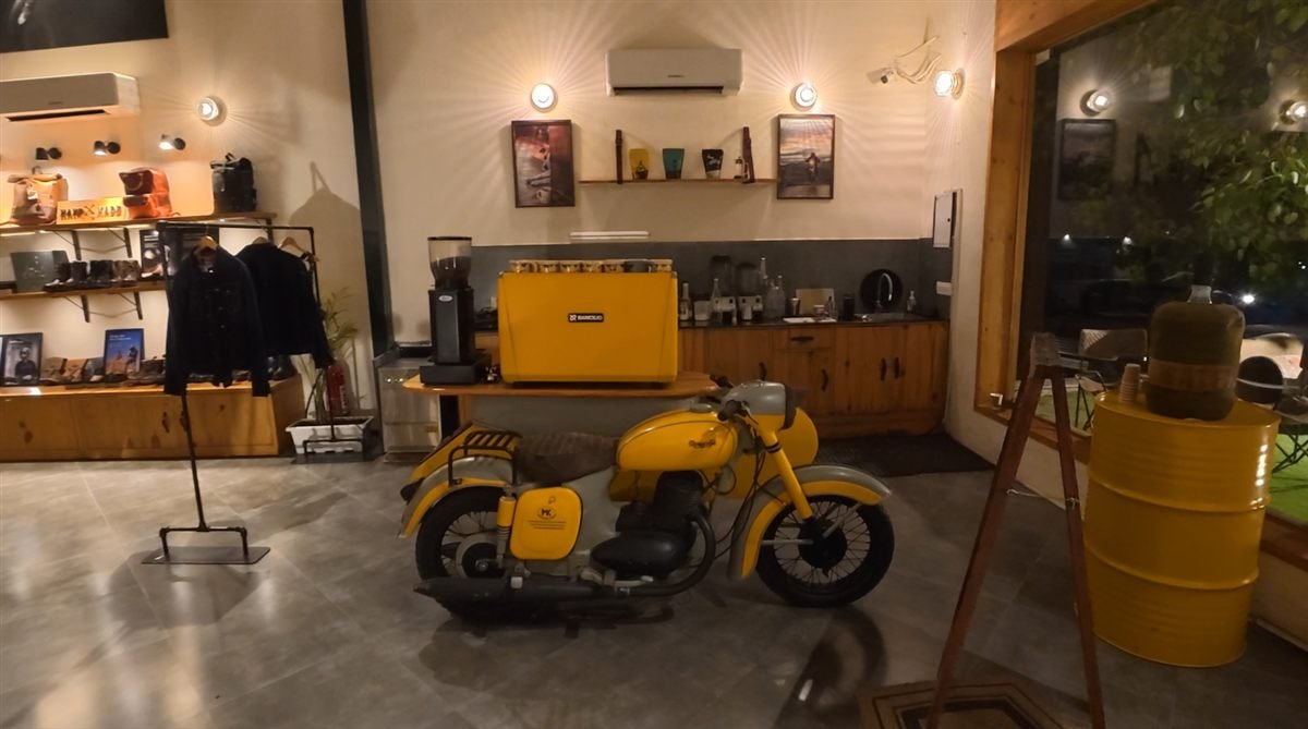 Trip Machine Cafe Gurgaon interior with vintage yellow motorcycle and coffee counter