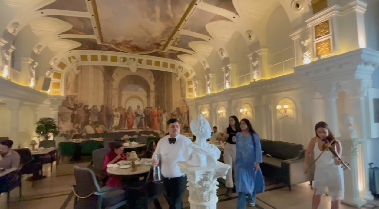 Grand two-level dining room with classical mural and sculptures at Begeterre Gurgaon