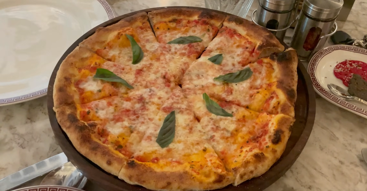 Fresh thin-crust vegetarian pizza with basil served at Begeterre Gurgaon