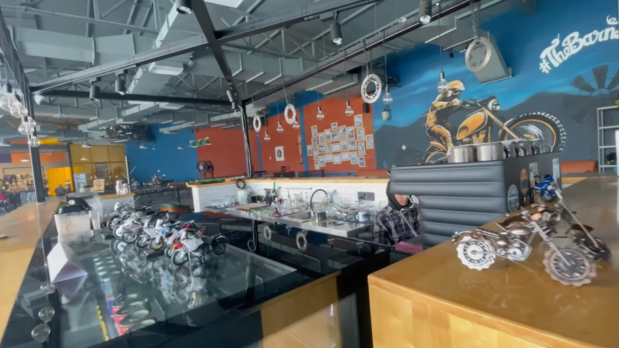 Cafe counter with biker mural and miniature motorcycle models at The Biker's Barn