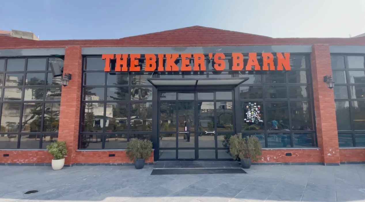 Brick and glass exterior of The Biker's Barn cafe in Gurgaon