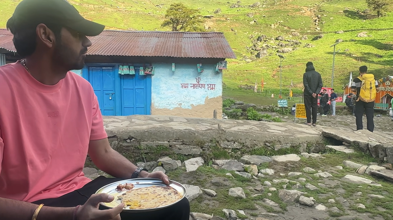 Creator eating a roti meal outdoors near Madhyamaheshwar Temple