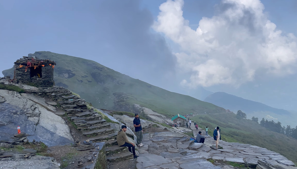 Stone steps and a small hut on the exposed upper route