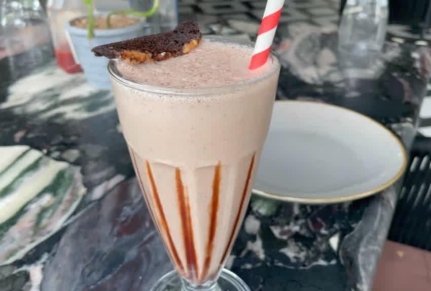 Chocolate-coloured shake served in a tall glass at The Sunroom