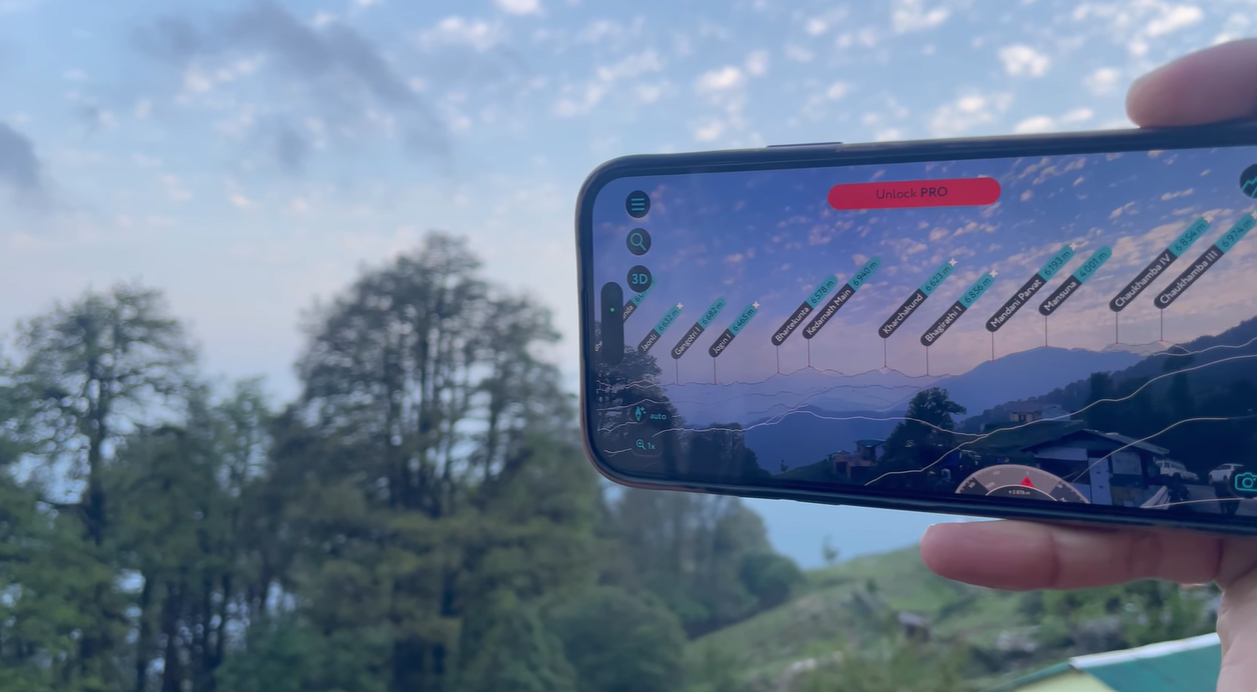 Phone showing mountain labels over a view from Chopta