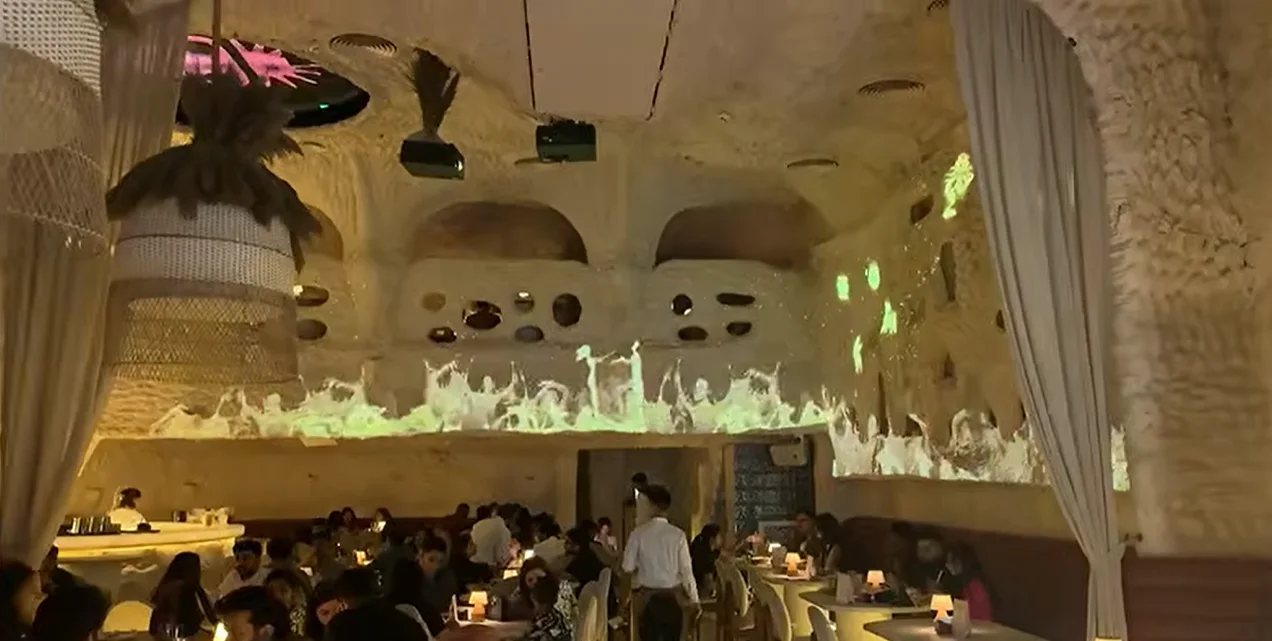 Busy lunch crowd seated inside the cave-themed Covah The Cavern dining hall