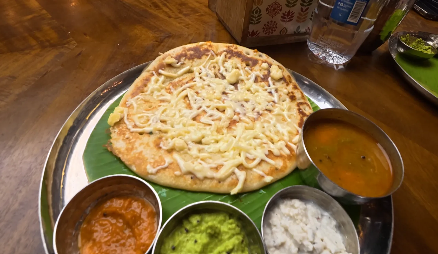 Cheese uttapam served with sambar and three chutneys at Daksina Bhawan