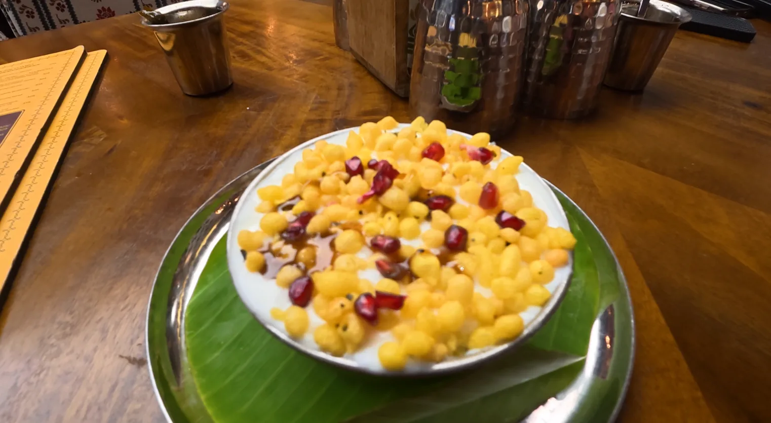 Dahi vada topped with boondi and pomegranate at Daksina Bhawan