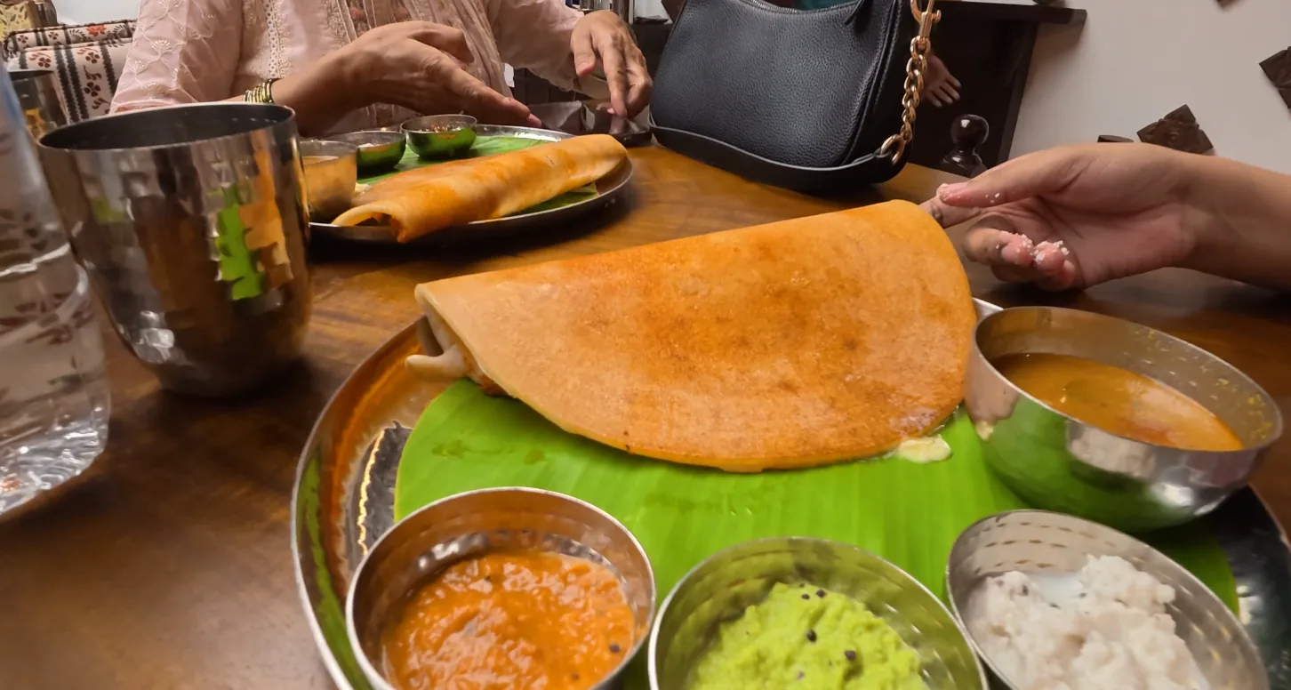 Golden dosa served with sambar and three chutneys at Daksina Bhawan