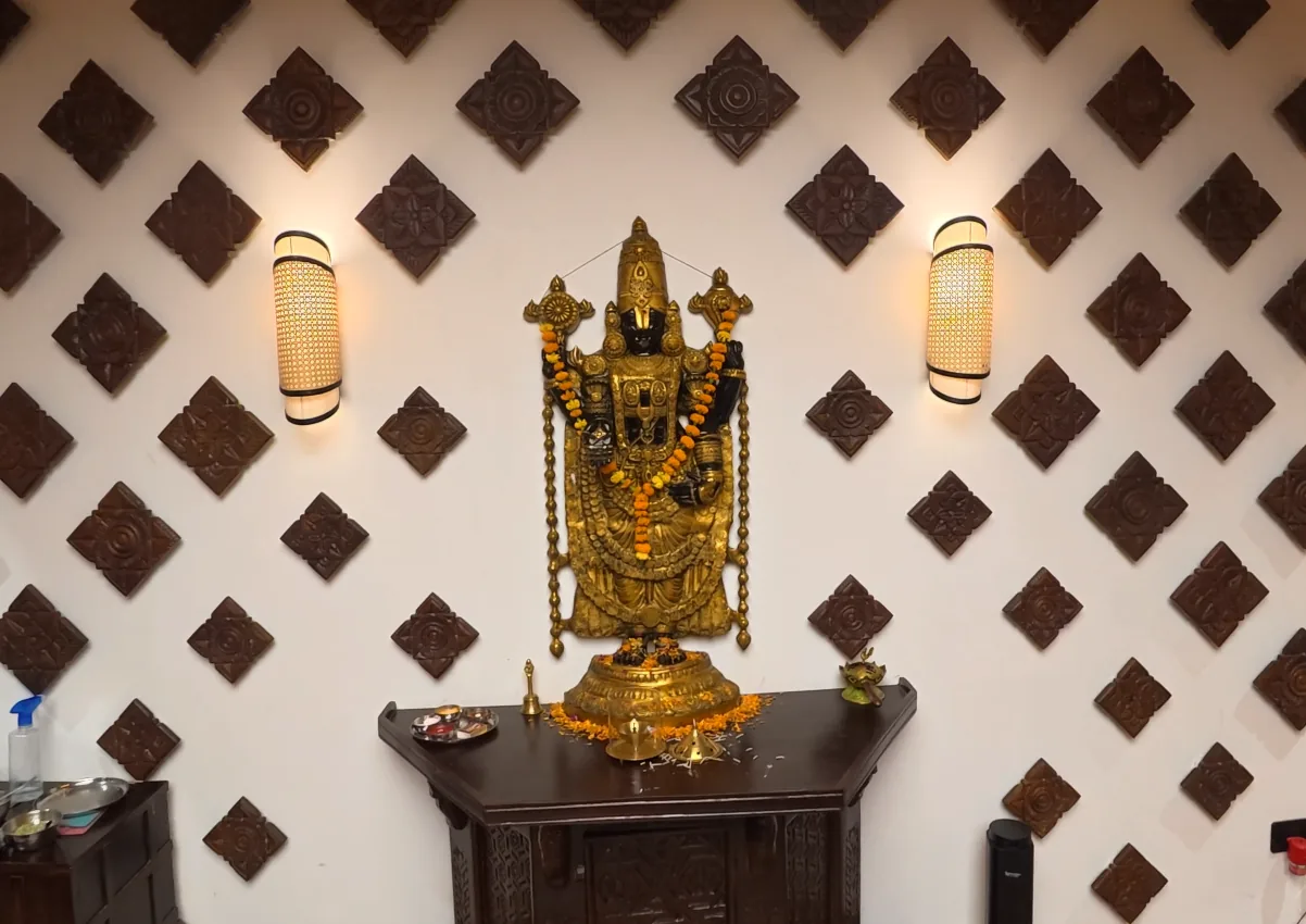 Decorative deity display on a patterned wall inside Daksina Bhawan