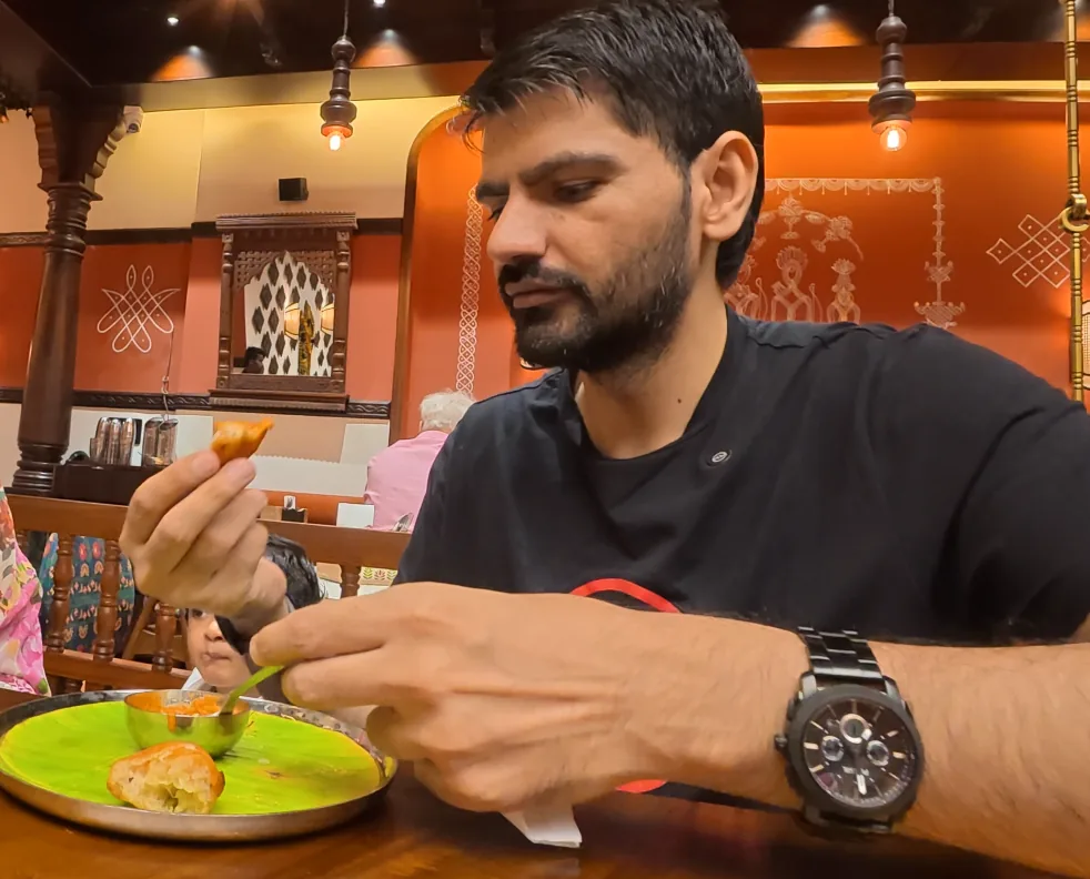 Foodandtraveltales creator tasting paniyaram at Daksina Bhawan
