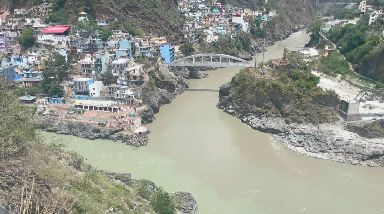 Two differently coloured rivers meeting below a bridge at Devprayag