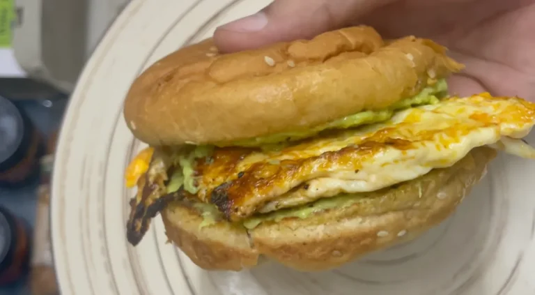 Finished egg avocado burger with chilli oil omelette and avocado spread in a toasted bun