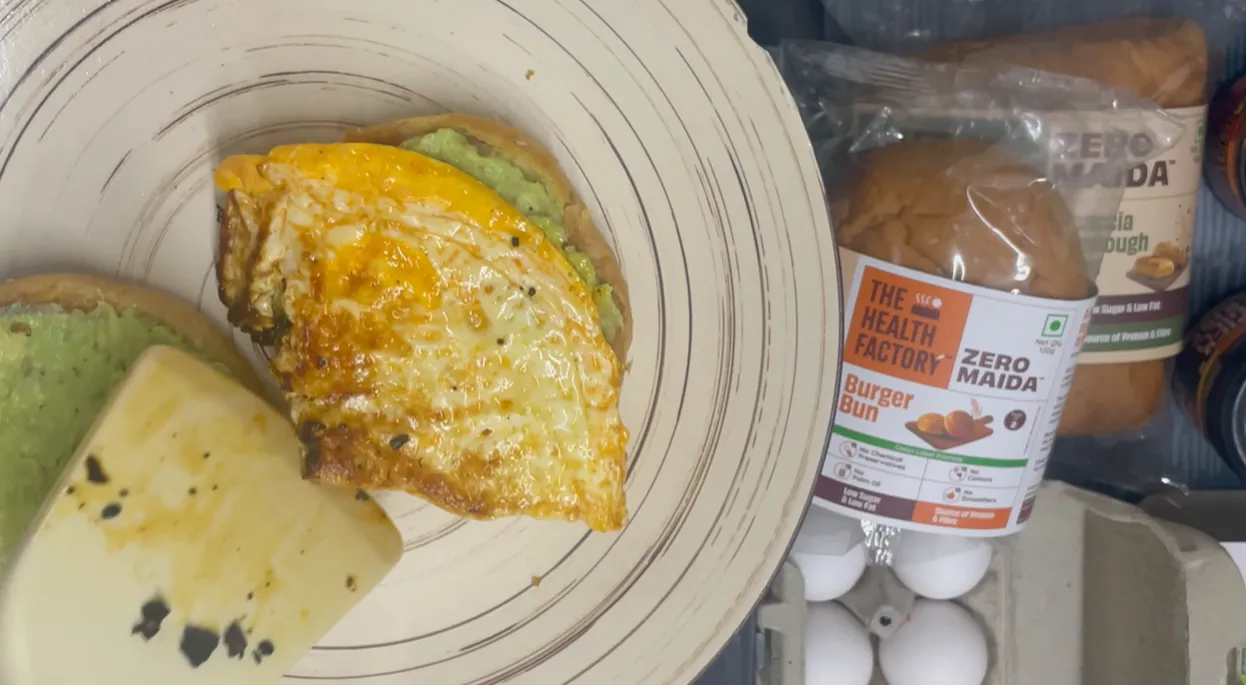 Folded chilli oil egg placed on a bun spread with avocado