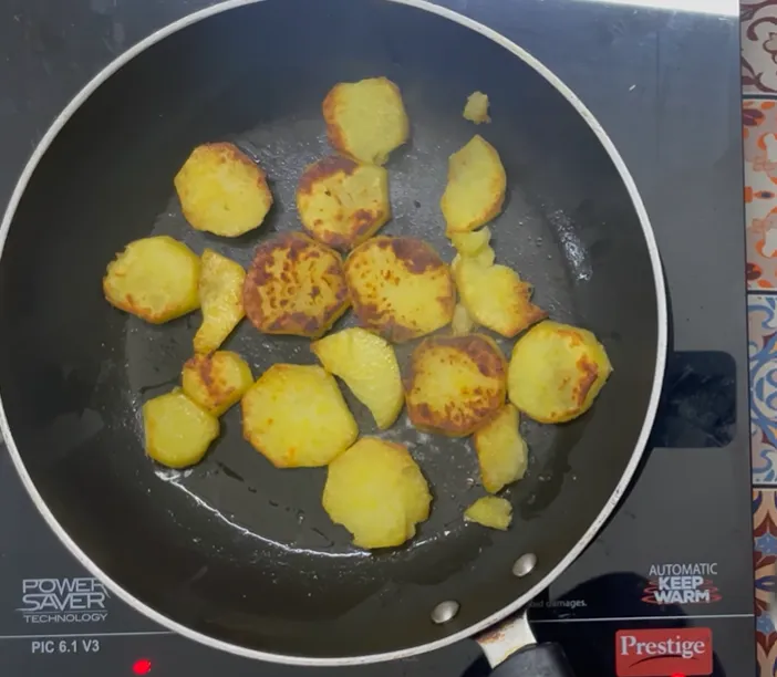 Sweet potato slices browned on both sides in a non-stick pan