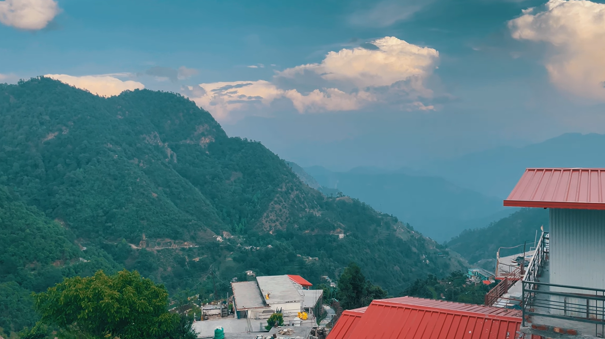 Mountain valley and village rooftops seen from a Kanakchauri homestay