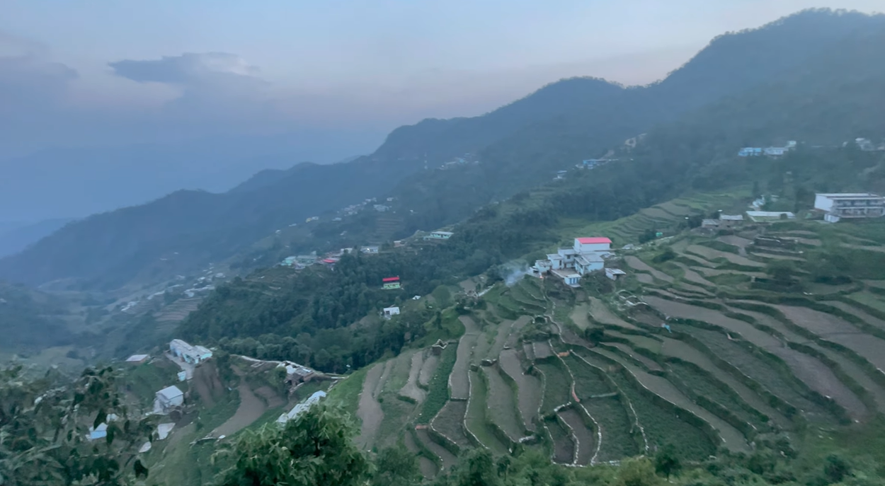 Terraced hillsides and scattered homes in the valley below Kanakchauri