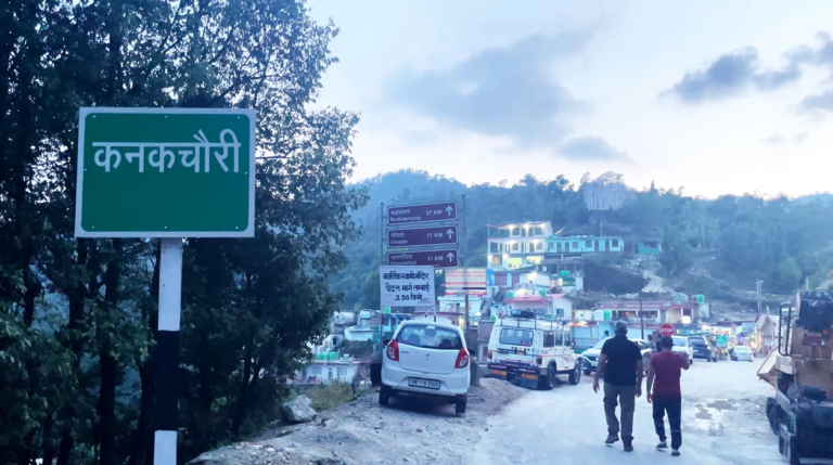Road sign reading Kanakchauri beside the road toward Kartik Swami temple