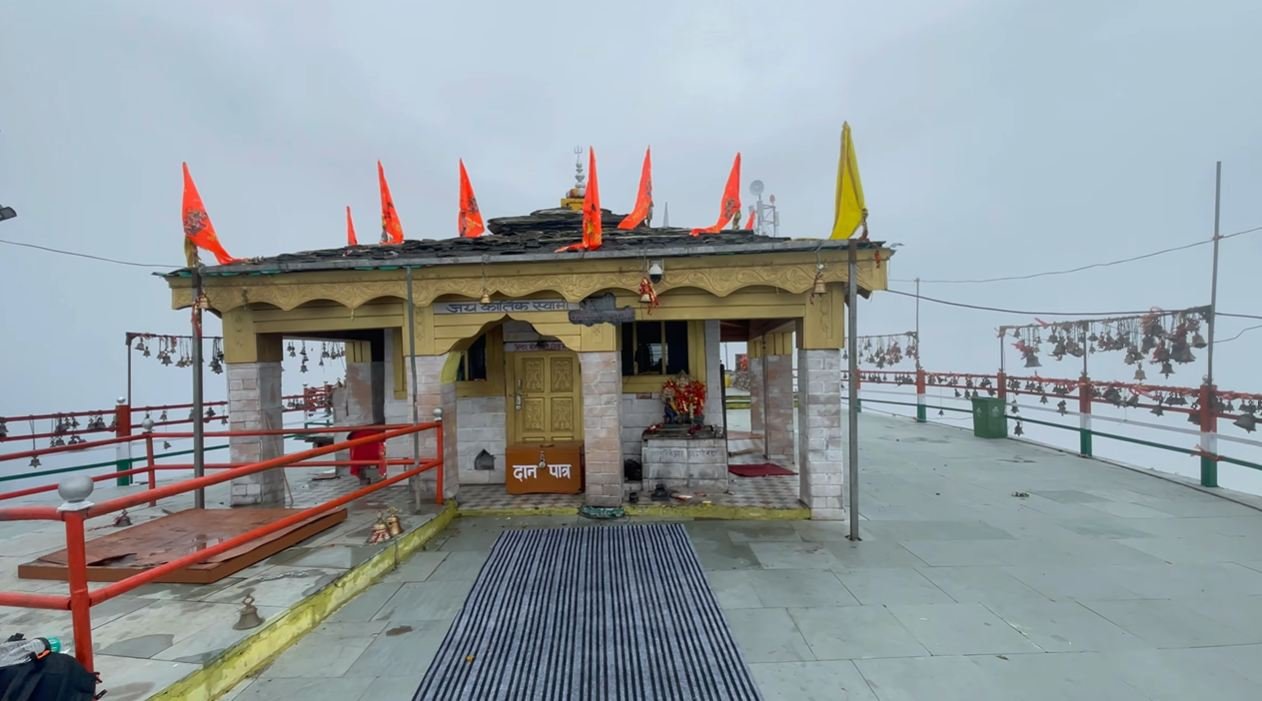 Kartik Swami Temple entrance with saffron flags