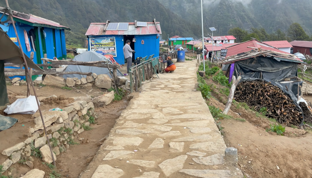 Stone walkway between small lodgings near Madhyamaheshwar Temple
